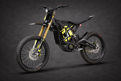 Sur-Ron electric dirt bike in black and yellow on a dark studio background — lightweight off-road e-moto available at Ride VZN.
