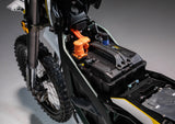 Close-up view of the Sur Ron Ultra Bee battery compartment showing the high-voltage connectors and removable battery pack.